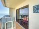 Balcony with ocean view and striped chairs and a table at 1513 Ocean Shore Blvd # 9E, Ormond Beach, FL 32176