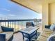 Spacious balcony overlooking the ocean, with comfortable seating and outdoor table at 1513 Ocean Shore Blvd # 9E, Ormond Beach, FL 32176