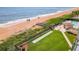 Aerial view of beach, pool, shuffleboard, and walkway at 1513 Ocean Shore Blvd # 9E, Ormond Beach, FL 32176