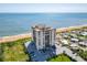 Aerial view of beachfront building with ocean and residential areas at 1513 Ocean Shore Blvd # 9E, Ormond Beach, FL 32176