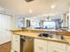 Kitchen features stainless steel dishwasher and wood countertop at 1513 Ocean Shore Blvd # 9E, Ormond Beach, FL 32176