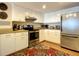 Galley kitchen with stainless steel appliances and wood floors at 1513 Ocean Shore Blvd # 9E, Ormond Beach, FL 32176
