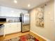 Kitchen with stainless steel appliances and floral area rug at 1513 Ocean Shore Blvd # 9E, Ormond Beach, FL 32176