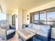 Outdoor patio furniture on a tiled balcony overlooking the ocean at 1513 Ocean Shore Blvd # 9E, Ormond Beach, FL 32176