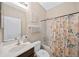 Bathroom with tub shower combo and floral shower curtain at 165 Captain Hook Way, Davenport, FL 33837