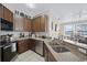 Modern kitchen with stainless steel appliances and granite countertops at 165 Captain Hook Way, Davenport, FL 33837