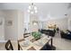 Bright dining room with a chandelier and seating for four at 165 Captain Hook Way, Davenport, FL 33837