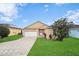 House exterior view showcasing the front yard and driveway at 165 Captain Hook Way, Davenport, FL 33837