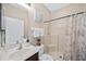 Bathroom with single vanity, shower, and neutral decor at 165 Captain Hook Way, Davenport, FL 33837