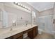 Bathroom with double vanity, large mirror, and shower at 165 Captain Hook Way, Davenport, FL 33837