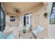 Relaxing patio with seating area, ceiling fan, and hammock at 165 Captain Hook Way, Davenport, FL 33837