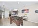 Casual game room featuring a foosball table and a large TV at 165 Captain Hook Way, Davenport, FL 33837