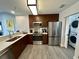 Modern kitchen with stainless steel appliances and wood cabinets at 14501 Grove Resort Ave # 2541, Winter Garden, FL 34787