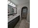 Elegant bathroom with dual sinks, large mirror, and access to a walk-in shower at 242 Aidan'S Lndg, Haines City, FL 33844