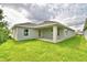 The back of the house has a large covered patio and grassy area at 1278 Tagliamento Ln, Haines City, FL 33844