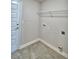 Laundry room with tile floor, shelving, and white door at 1278 Tagliamento Ln, Haines City, FL 33844