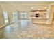 Open kitchen with island, stainless steel appliances, and tiled floor at 1278 Tagliamento Ln, Haines City, FL 33844