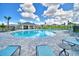 Relaxing kidney-shaped pool with surrounding lounge chairs at 1278 Tagliamento Ln, Haines City, FL 33844