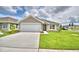 A charming one-story house with a two-car garage and well-manicured lawn at 1278 Tagliamento Ln, Haines City, FL 33844