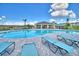 Inviting community pool with lounge chairs and a shaded seating area at 1278 Tagliamento Ln, Haines City, FL 33844