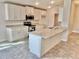 Modern kitchen with white cabinets, granite countertops and island at 1278 Tagliamento Ln, Haines City, FL 33844