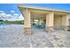 Covered patio area with tables and chairs near the pool at 1278 Tagliamento Ln, Haines City, FL 33844