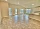 Spacious living room with tile floors and access to backyard at 1278 Tagliamento Ln, Haines City, FL 33844