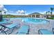 Community pool with plenty of lounge chairs at 1278 Tagliamento Ln, Haines City, FL 33844