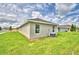Side view of a house showing a large yard and AC unit at 1278 Tagliamento Ln, Haines City, FL 33844