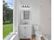 Clean bathroom with a gray vanity, toilet and a walk in shower at 260 Deer Isle Dr, Winter Garden, FL 34787