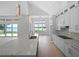 Modern kitchen with lake views and white cabinetry at 260 Deer Isle Dr, Winter Garden, FL 34787