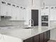 Modern kitchen with white cabinets, marble countertops, and high-end appliances at 260 Deer Isle Dr, Winter Garden, FL 34787