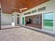 Covered patio with wood ceilings, sliding glass doors, and backyard access at 260 Deer Isle Dr, Winter Garden, FL 34787