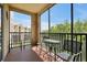Screened balcony with metal table and chairs at 1375 Tuscana Ln # 1308, Davenport, FL 33896