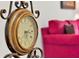 Ornate clock in living room with a red sofa in the background at 1375 Tuscana Ln # 1308, Davenport, FL 33896