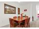 Dining room with a wood table and chairs, adjacent to kitchen at 1375 Tuscana Ln # 1308, Davenport, FL 33896