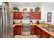Modern kitchen with stainless steel appliances and wood cabinets at 1375 Tuscana Ln # 1308, Davenport, FL 33896