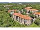 Aerial view of apartment buildings nestled in lush greenery at 1375 Tuscana Ln # 1308, Davenport, FL 33896