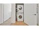 Stackable washer and dryer in a well-lit laundry closet at 1375 Tuscana Ln # 1308, Davenport, FL 33896