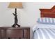 Dark wood nightstand with a unique table lamp at 1375 Tuscana Ln # 1308, Davenport, FL 33896