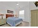 Bedroom with a light blue comforter and light wood nightstand at 1375 Tuscana Ln # 1308, Davenport, FL 33896