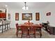 Bright dining room features a wood table with six chairs, hardwood floors, and decorative wall art at 1375 Tuscana Ln # 1308, Davenport, FL 33896