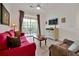 Living room with red couch and balcony access at 1375 Tuscana Ln # 1308, Davenport, FL 33896