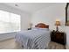 Bright bedroom with a comfortable bed, window, and wood nightstands at 1375 Tuscana Ln # 1308, Davenport, FL 33896