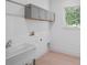 Laundry room with gray cabinets and utility sink at 260 Deer Isle Dr, Winter Garden, FL 34787
