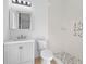 Bathroom with gray vanity and pebble shower floor at 260 Deer Isle Dr, Winter Garden, FL 34787
