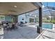 Covered patio with dining area overlooking the pool at 1317 Spring Lake Ter, Ocoee, FL 34761