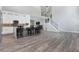 Modern kitchen features white cabinets, an island with seating, and gray wood-look flooring at 1317 Spring Lake Ter, Ocoee, FL 34761