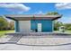Detached blue metal storage building with roll-up door at 1317 Spring Lake Ter, Ocoee, FL 34761