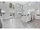 Modern kitchen with an island, stainless steel appliances, and grey flooring at 1317 Spring Lake Ter, Ocoee, FL 34761